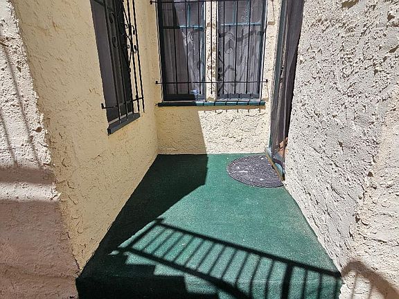 Enclosed private patio and steps leading to breezeway (not pictured)