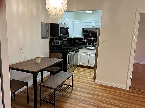View of Dining are with a set of 4 seating. View of a full kitchen