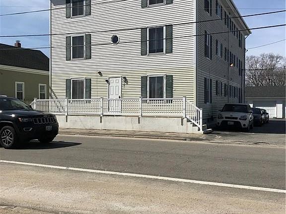 Front of building, north side parking and side of building, garage in rear.