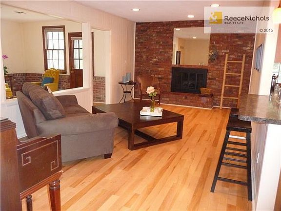 Spacious family room boasts hardwood floor, fireplace and is open to kitchen and sunroom.