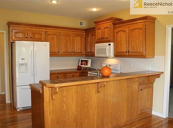 Fantastic Kitchen with beautiful cabinets, gleaming hardwood floors, and great counter top space.