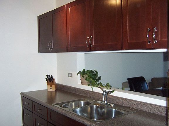 Renovated kitchen includes ceramic tile, double oven, electric stove.