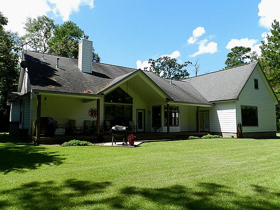View of back of house showing the large covered back porch and additional deck for entertaining.