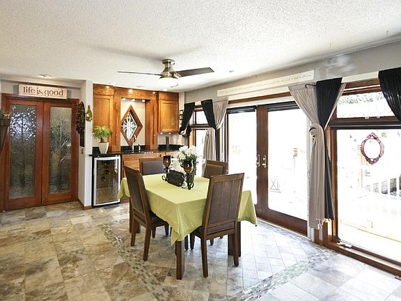 Dining area looks out over wonderful patio area.  Wet bar area in dining room with two wine fridges and hidden cabinets.