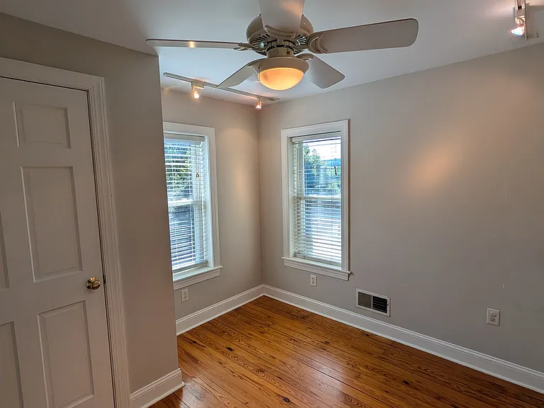 A second bedroom or office on the second floor has a closet, dimmable track lighting and a ceiling fan.
