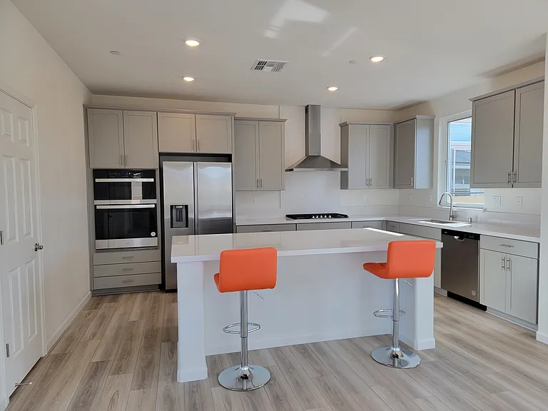 Kitchen with 36 inch Gas cooktop, stainless steel hood, built in Microwave, Oven and Counter depth refrigerator