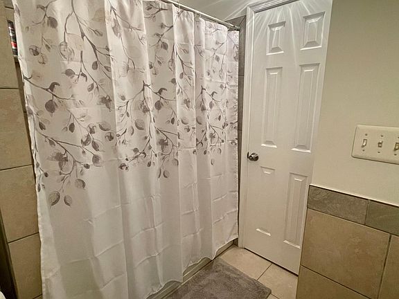 Indulge in luxury with this apartment's bathroom featuring a full-sized shower with a tub. The modern fixtures and tasteful finishes create a stylish and inviting space for both quick showers and relaxing baths. It's a haven of relaxation and convenience