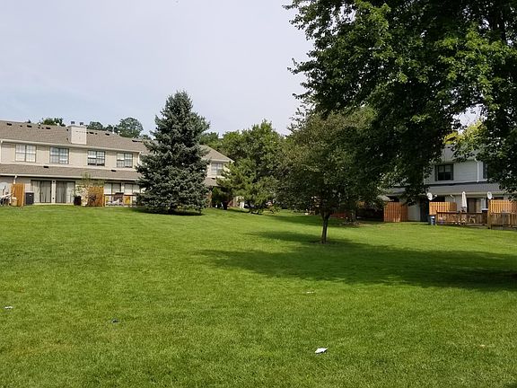 Patio opens to lush green backyard for kids to play or hangout for barbecue.