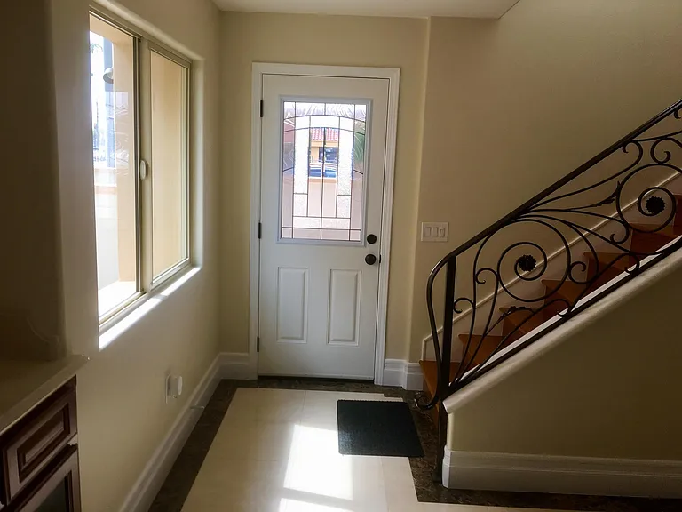 AREA SHOWS STAIRWELL AND SIDE DOORWAY TO PATIO
