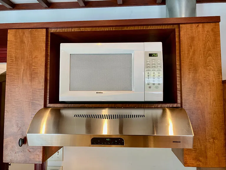 Hood over cooktop with spot for microwave. The microwave is not an included appliance on the lease.