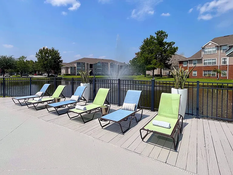 Residents can enjoy sun-drenched relaxation by the water's edge with rows of loungers offering tranquility by the water. Make this your ultimate relaxation destination!
