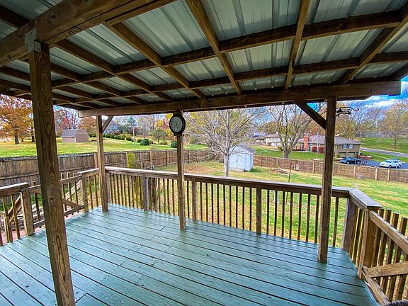 Covered back deck perfect for relaxing. Firepit in the backyard, and a concrete slab for a grill.
