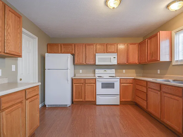 Kitchen has a modern vinyl flooring compared to the one depicted in the picture.