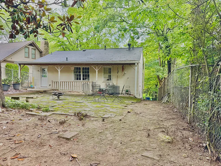 Backyard with patio, planters, and porch area