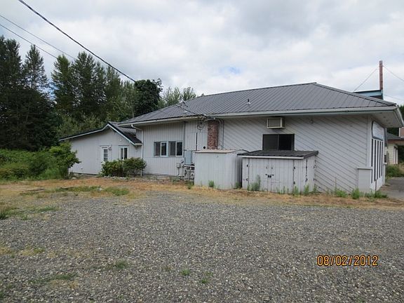 Left side view. Door just past the shrub is an entry door into apartment