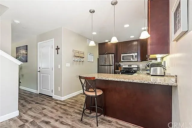 Fully equipped kitchen with granite top and beautiful wood cabinetry