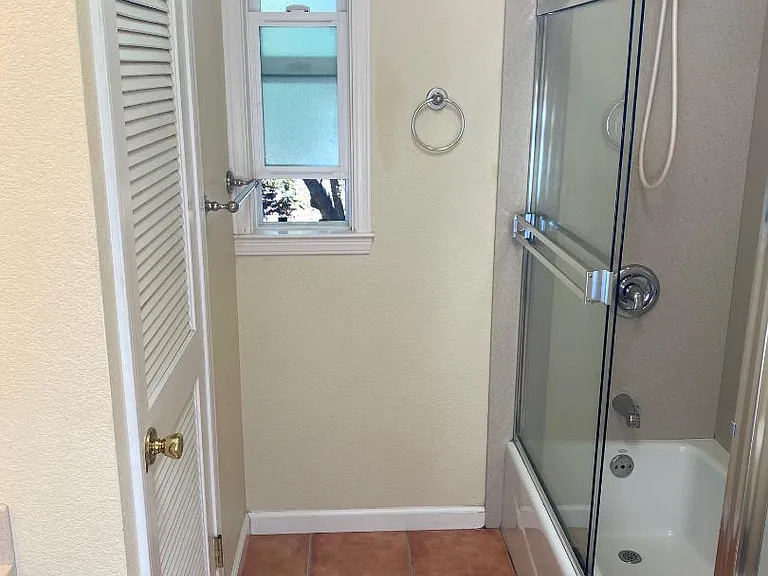 Bathroom with enclosed washer and dryer.