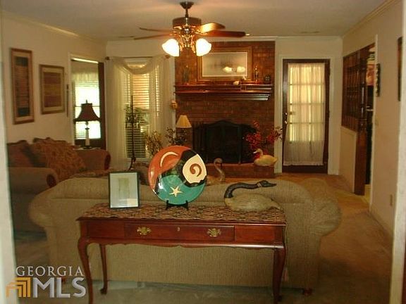 FAMILY ROOM WITH GAS LOG FIREPLACE & EXIT TO COVERED PATIO