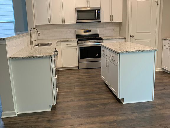 Kitchen with granite, upgraded cabinets, pantry, gas stove, microwave, refrigerator and dish washer