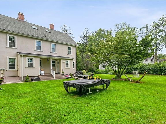 Back of Structure - Rear view of house with a yard and a patio area