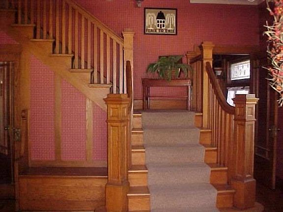 Foyer with large closet under stairs and storage bench with lift up lid seat!