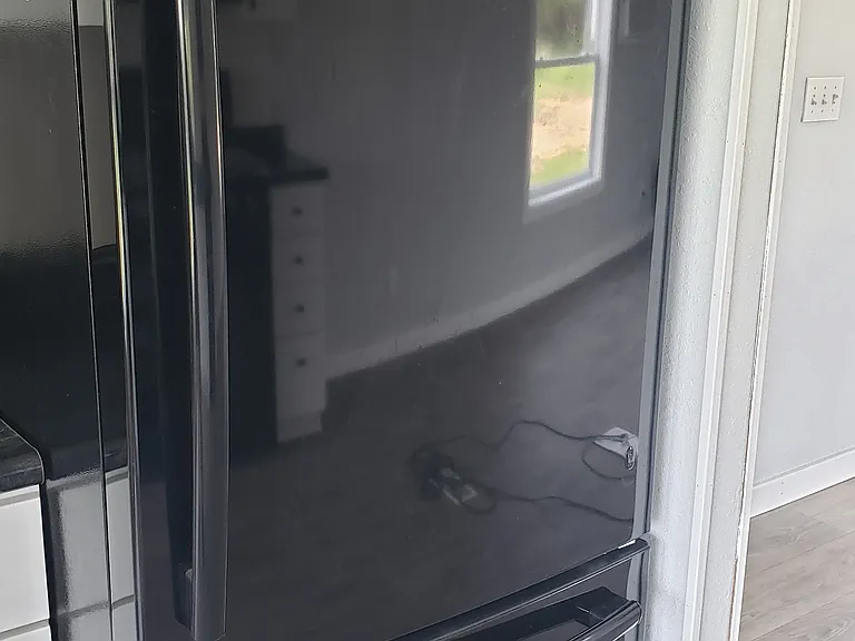 GE Frig with ice maker, Freezer on bottom with pull out drawer.