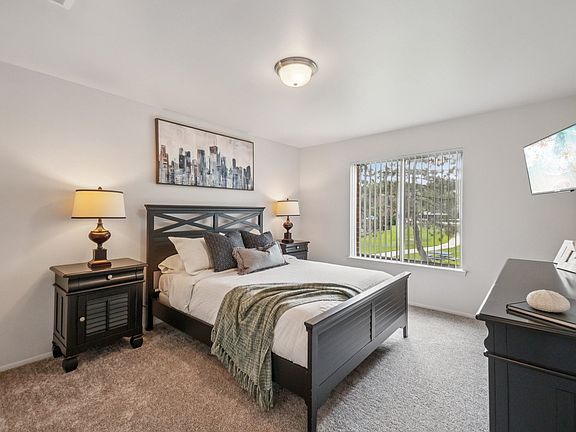 Cozy bedroom with ample storage space at Drawbridge Apartments in Harrison Township, MI.