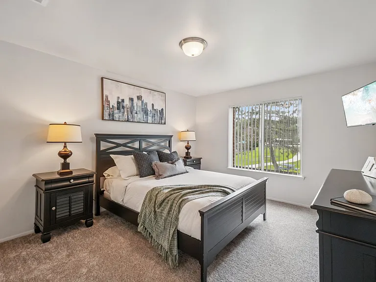 Cozy bedroom with ample storage space at Drawbridge Apartments in Harrison Township, MI.