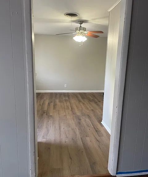 2 living areas. New Flooring and fresh paint, this is the view into the front living area from the den.