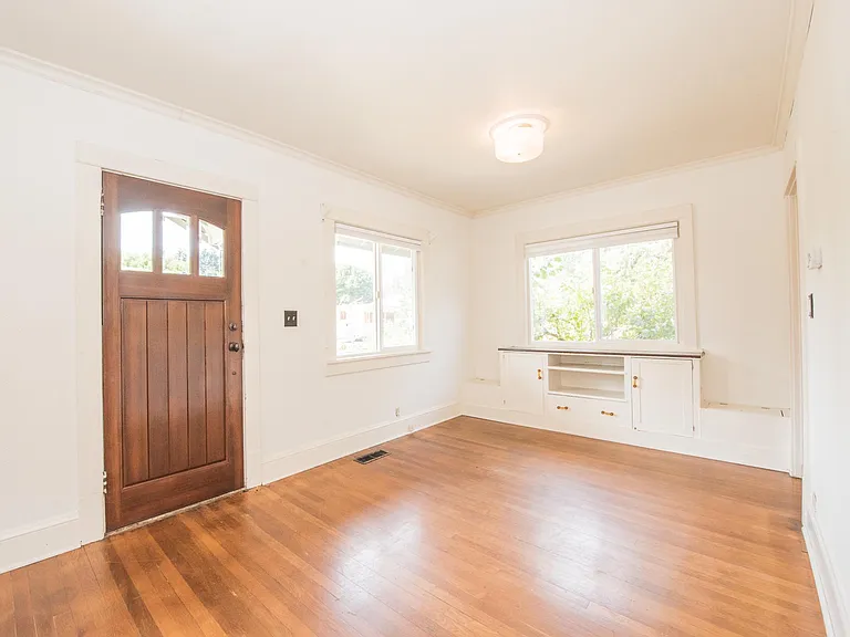 wood floors and a built-in storage bench