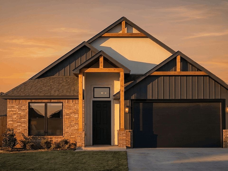Modern suburban house at sunset with brick and dark siding, wooden accents, a black front door, larg