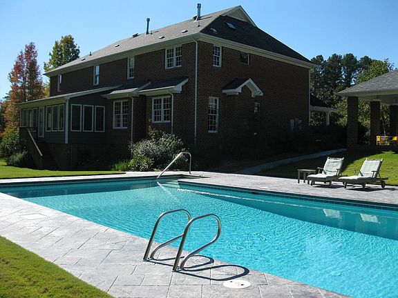 Back yard has SE exposure; 20x40 pool; overlooks 3-acre pond; outdoor kitchen