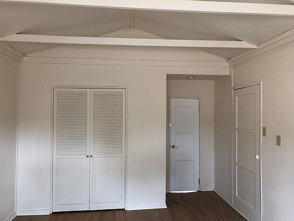 master bedroom with vaulted ceiling