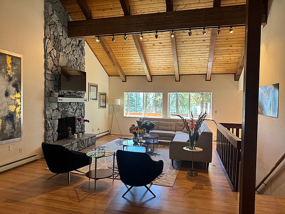 Mid century modern living room with huge lake views out large 4X6' windows.