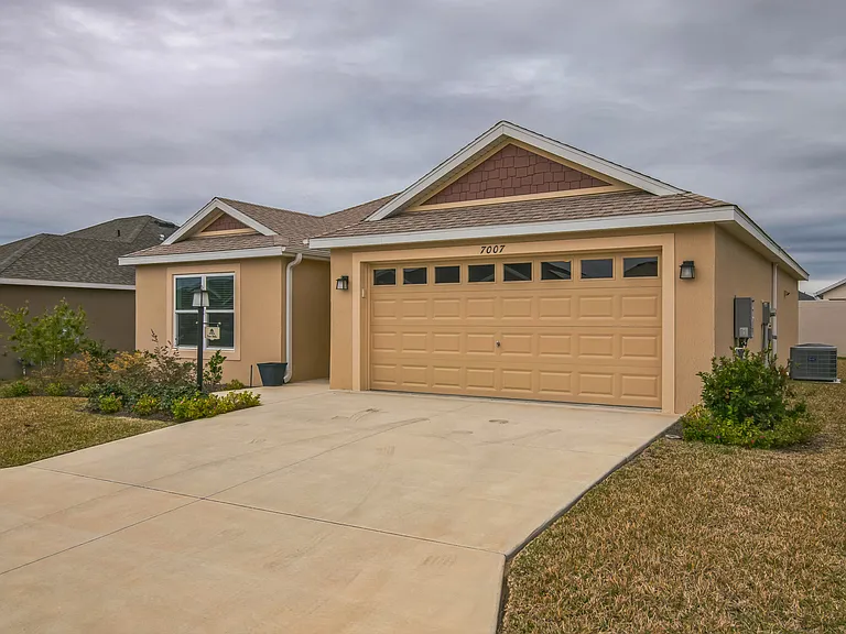 Front View of the House, Driveway, and Side Yard.