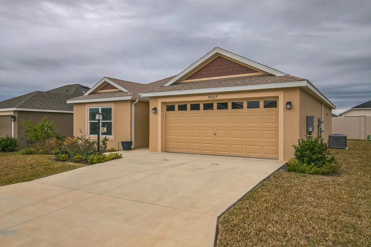 Front View of the House, Driveway, and Side Yard. - 7007 Minchew Cir