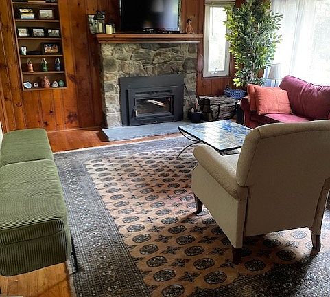 Sunny living room with fireplace.