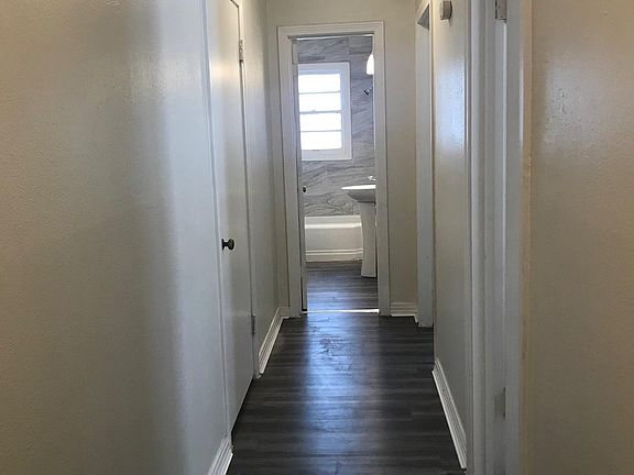 Hallway with bathroom at the end