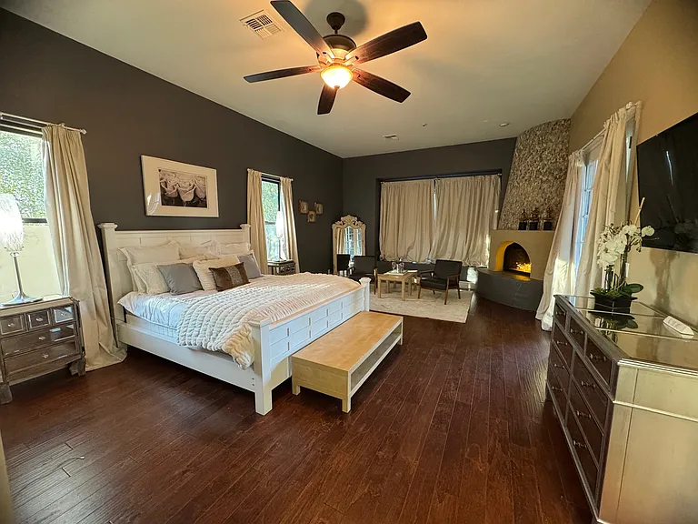 Primary bedroom with cozy fireplace and separate entrance to pool.