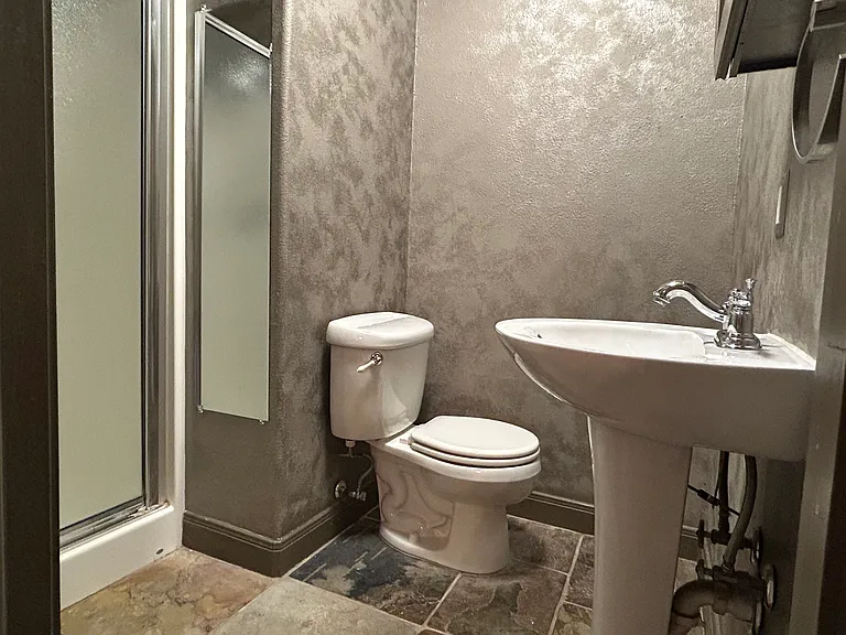 upstairs bathroom with shower, toilet, pedestal sink and medicine cabinet