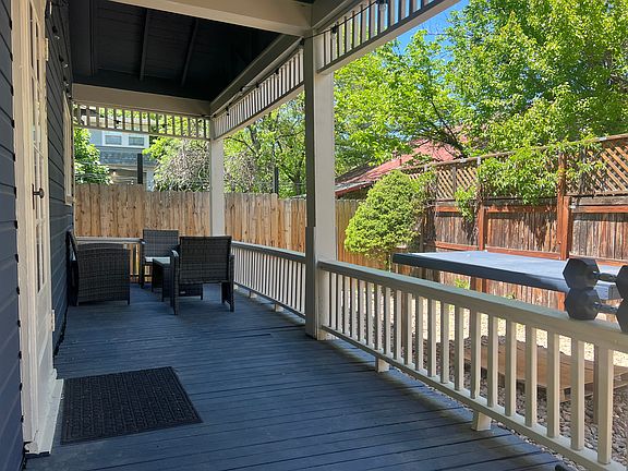 A covered porch runs along the entire north side of the home.