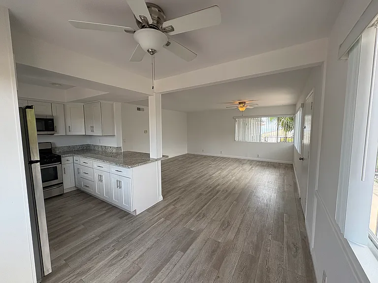 Open concept eat in kitchen and living room.