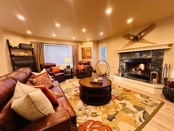 One of two living rooms in the home. This space has a wood burning fireplace (duraflame logs provided), italian leather power reclining chairs and sofa and is adjacent to the kitchen. There is a powder room off the living space. Very cozy!