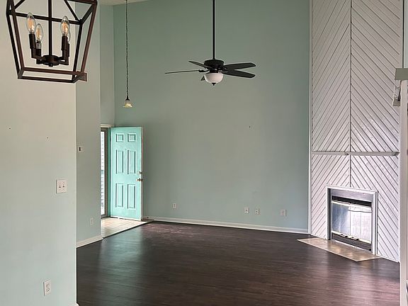 Open living space with high ceilings and plenty of natural light