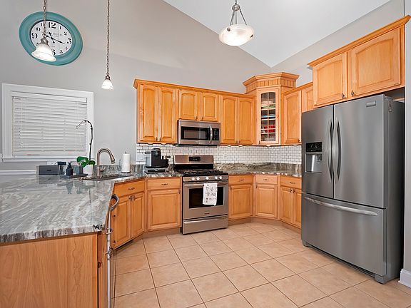 Tiered upscale cabinetry with stainless Frigidaire Gallery appliances. Newer granite counters, subwa