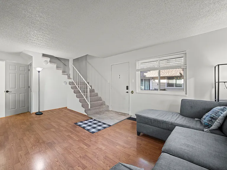Bright and inviting living room featuring abundant natural light and an open layout ideal for everyday living and entertaining.