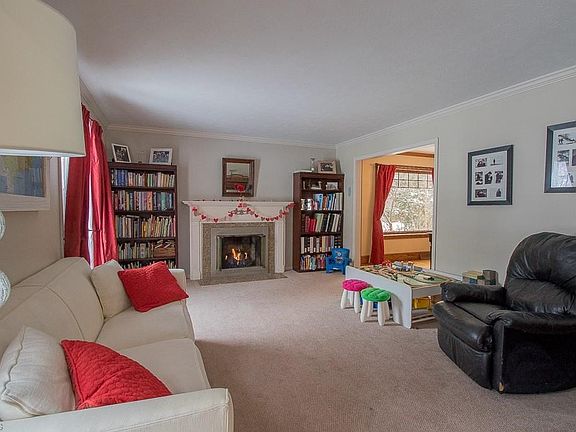 Formal living room with gas fireplace and decorative mantel.