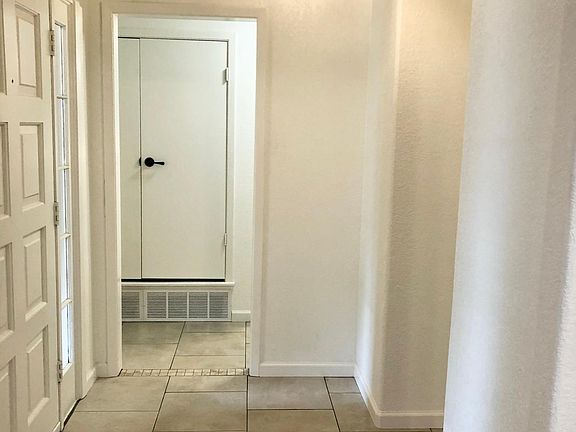 The entry way is spacious. The front door is flanked by clear window that allow natural light into the home. The front porch is huge and ready for your outdoor furniture.