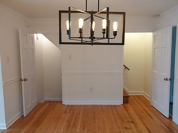 From dining room, you'll find stairs to the very large basement with washer/dryer on the left and stairs to upstairs bedrooms and full bath on the right. Both can be closed off with solid wood doors.