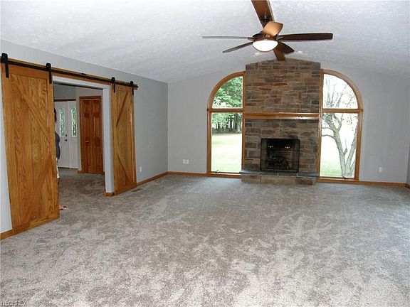 vaulted ceiling, stone fireplace (gas or wood), custom solid oak barn doors, new flooring